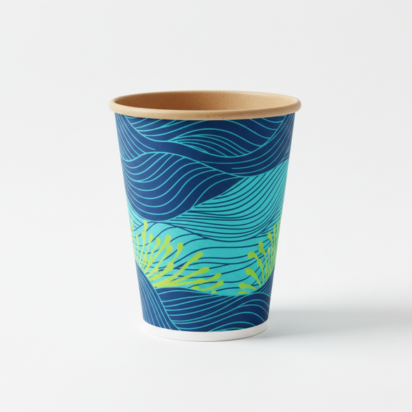 A printed double wall paper cup, blue and green wave pattern, on a white ground